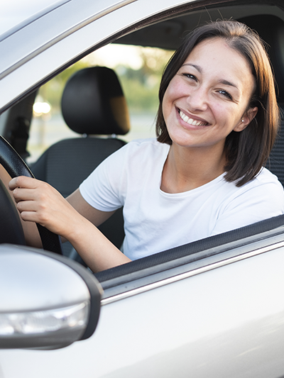 happy woman driver behind the wheel